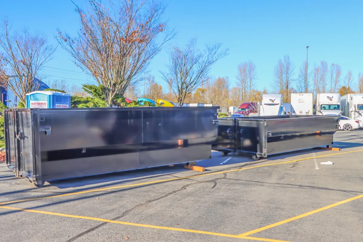 Professional dumpster rental service with roll-off container on residential driveway in Cape Elizabeth